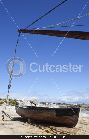 Wooden boat moored by sea wooden boat moored by sea stock photo, crane and wooden fishing boat on edge of sea by Stephen Clarke