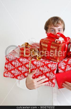 To use this stock image in your creative project, please select the size you need over to the right and click the "Add to Cart" button.
Your downloaded image will come with the Cutcaster watermark removed so don’t worry about the watermark you see on this page. Presenting alot of gifts stock photo, A man presenting several christmas presents by Lasse Kristensen@gmail.com