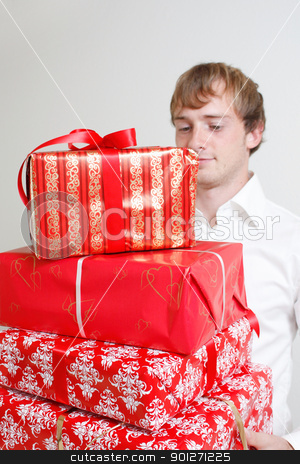 To use this stock image in your creative project, please select the size you need over to the right and click the "Add to Cart" button.
Your downloaded image will come with the Cutcaster watermark removed so don’t worry about the watermark you see on this page. Presenting alot of gifts stock photo, A man presenting several christmas presents by Lasse Kristensen@gmail.com