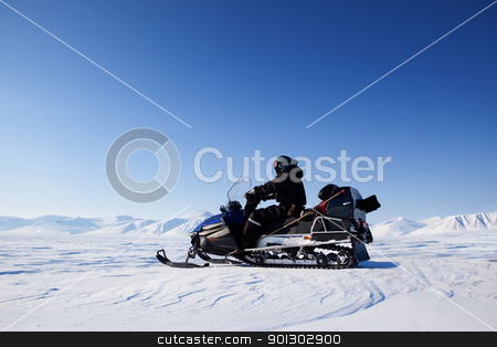 To use this stock image in your creative project, please select the size you need over to the right and click the "Add to Cart" button.
Your downloaded image will come with the Cutcaster watermark removed so don’t worry about the watermark you see on this page. Snowmobile Winter Landscape stock photo, A snowmobile on a frozen lake against a winter landscape with mountains by Tyler Olson