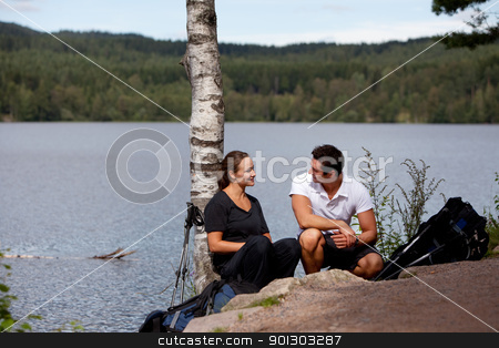 To use this stock image in your creative project, please select the size you need over to the right and click the "Add to Cart" button.
Your downloaded image will come with the Cutcaster watermark removed so don’t worry about the watermark you see on this page. Camping Rest stock photo, A man and woman taking a break while on a camping hike by Tyler Olson