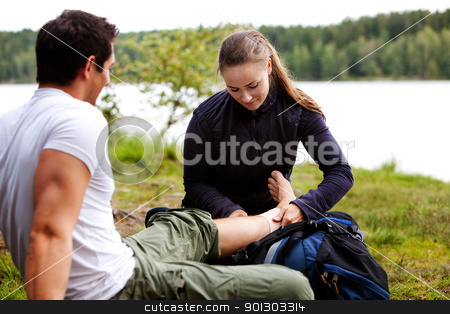 To use this stock image in your creative project, please select the size you need over to the right and click the "Add to Cart" button.
Your downloaded image will come with the Cutcaster watermark removed so don’t worry about the watermark you see on this page. Camping First Aid stock photo, A woman applying an ankle bandage on a male camper by Tyler Olson