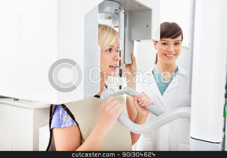Panoramic Dental X-ray Panoramic Dental X-ray stock photo, A young dentist taking a panoramic digital X-ray of a patient`s teeth by Tyler Olson