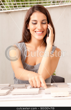 To use this stock image in your creative project, please select the size you need over to the right and click the "Add to Cart" button.
Your downloaded image will come with the Cutcaster watermark removed so don’t worry about the watermark you see on this page. Designer Stone Sample stock photo, An interior designer / architect on the phone choosing a stone sample swatch by Tyler Olson