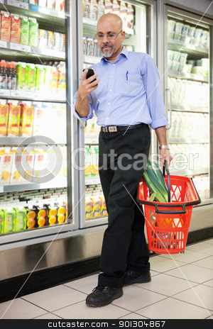 To use this stock image in your creative project, please select the size you need over to the right and click the "Add to Cart" button.
Your downloaded image will come with the Cutcaster watermark removed so don’t worry about the watermark you see on this page. Man with Grocery Basket and Mobile Phone stock photo, Man with shopping basket looking at cell phone while walking in shopping store by Tyler Olson