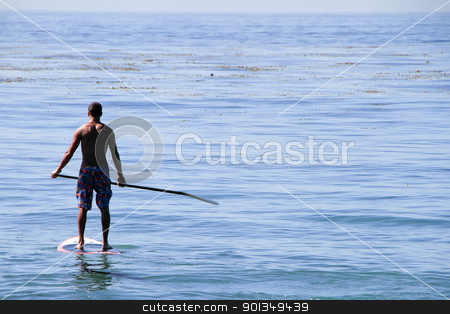 To use this stock image in your creative project, please select the size you need over to the right and click the "Add to Cart" button.
Your downloaded image will come with the Cutcaster watermark removed so don’t worry about the watermark you see on this page. Paddle boarder surfer stock photo, back view of adult man standing on paddle board by Juliet N Newton