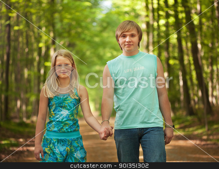 Children walking together Children walking together stock photo, Teenager brother and sister walking along the path in the woods by Mikhail Lavrenov