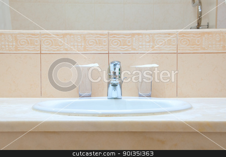 Hotel bathroom Hotel bathroom stock photo, White sink, chrome tap and two glasses in a hotel bathroom by Iryna Rasko