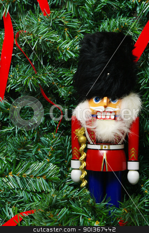 To use this stock image in your creative project, please select the size you need over to the right and click the "Add to Cart" button.
Your downloaded image will come with the Cutcaster watermark removed so don’t worry about the watermark you see on this page. Nutcracker and a wreath stock photo, A nutcracker against a christmas wreath with red ribbons by Ed Corey