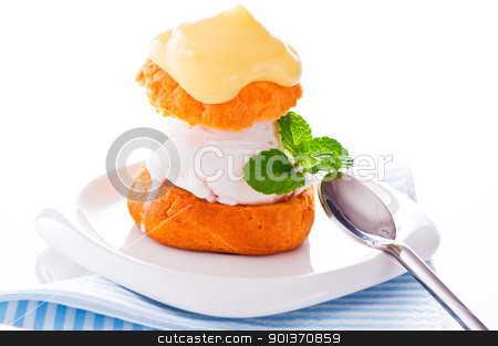 Profiterole in a small plate with ice cream vanilla sauce and mi Profiterole in a small plate with ice cream vanilla sauce and mi stock photo, Profiterole in a small plate with ice cream vanilla sauce and mint leaf on a white backgound by p.studio66
