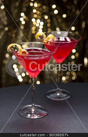 Cosmopolitan cocktail with lemon garnish Cosmopolitan cocktail with lemon garnish stock photo, Cosmopolitan cocktail with lemon garnish in front of a gold glitter background by Ulrich Schade