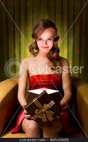 Magic gift box. Magic gift box. stock photo, Beautiful young blond woman holding gift box in creative lighting. by exvivo