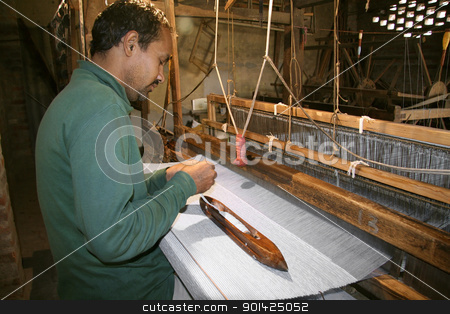 To use this stock image in your creative project, please select the size you need over to the right and click the "Add to Cart" button.
Your downloaded image will come with the Cutcaster watermark removed so don’t worry about the watermark you see on this page. weaving stock photo, weaver working handloom at workshop, delhi, india by Paul Prescott