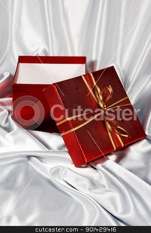 To use this stock image in your creative project, please select the size you need over to the right and click the "Add to Cart" button.
Your downloaded image will come with the Cutcaster watermark removed so don’t worry about the watermark you see on this page. red gift box stock photo, red gift box on white satin background by sutike