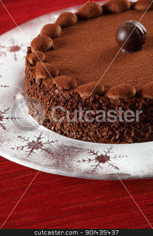 To use this stock image in your creative project, please select the size you need over to the right and click the "Add to Cart" button.
Your downloaded image will come with the Cutcaster watermark removed so don’t worry about the watermark you see on this page. Chocolate truffle cake stock photo, Photo of a delicious chocolate cake with truffle on top. Cake is on a plate with icing sugar with snowflake accents. Focus is on the front edge. by © Ron Sumners