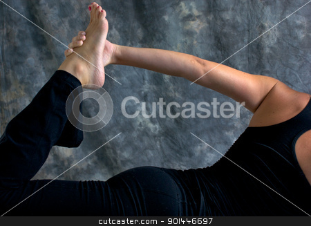 Close up of woman doing half bow yoga pose close up of woman doing half bow yoga pose stock photo, Close up of fit athletic woman doing half bow yoga pose showing arm and leg with hand holding foot in studio against a mottled background. by Stephen Orsillo