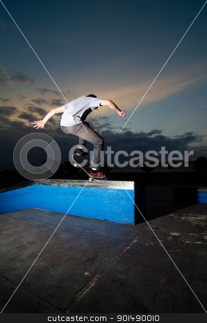 Skateboarder on a grind Skateboarder on a grind stock photo, Skateboarder on a grind at the local skatepark. by Homydesign