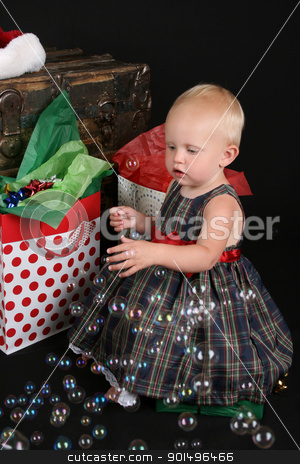 Christmas Bubbles Christmas Bubbles stock photo, Cute blond toddler infront of an antique trunk with christmas presents by Vanessa Van Rensburg