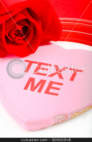 Valentines Day Message - Text Me! Valentines Day Message - Text Me! stock photo, A pink cookie and red rose use the tech-oriented phrase Text Me to send a flirtatious message to a loved one. by Karen Sarraga
