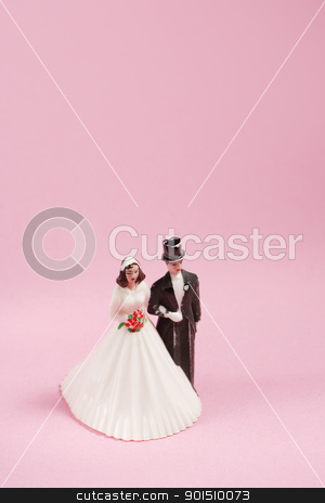To use this stock image in your creative project, please select the size you need over to the right and click the "Add to Cart" button.
Your downloaded image will come with the Cutcaster watermark removed so don’t worry about the watermark you see on this page. Old Cake Decoration stock photo, Vintage plastic wedding cake decoration on pink background. by Stocksnapper