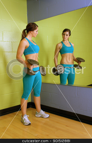 Beautiful Woman with Hand Weights (1) Beautiful Woman with Hand Weights (1) stock photo, A lovely young brunette with exceptional muscle tone works out with hand weights in front of a mirror. by Carl Stewart