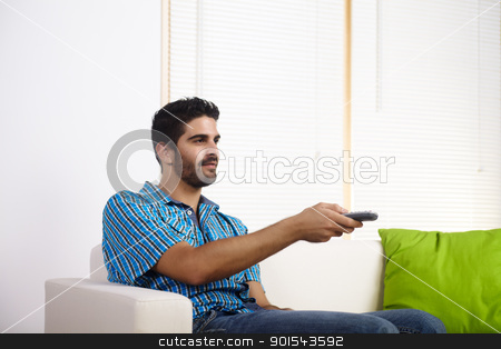 To use this stock image in your creative project, please select the size you need over to the right and click the "Add to Cart" button.
Your downloaded image will come with the Cutcaster watermark removed so don’t worry about the watermark you see on this page. Young man watching television stock photo, Young man watching television on a couch. by pablocalvog