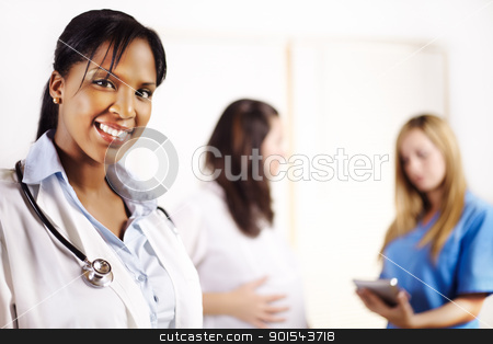 Doctor with one of his co-workers doctor with one of his co-workers stock photo, Portrait of a doctor with one of his co-workers talking with a patient in the background by pablocalvog