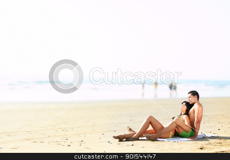 Couple lying on the beach couple lying on the beach stock photo, portrait of a sexy couple lying on the beach by pablocalvog