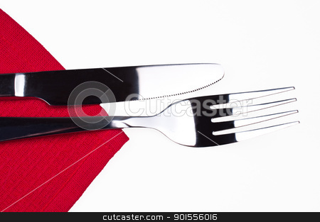 Knife and fork on red tablecloth isolated Knife and fork on red tablecloth isolated stock photo, Knife and fork on red tablecloth isolated close up by Nanisimova