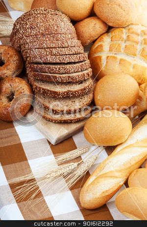 To use this stock image in your creative project, please select the size you need over to the right and click the "Add to Cart" button.
Your downloaded image will come with the Cutcaster watermark removed so don’t worry about the watermark you see on this page. Baked bread stock photo, Assortment of baked bread on a table cloth by Steve Mcsweeny