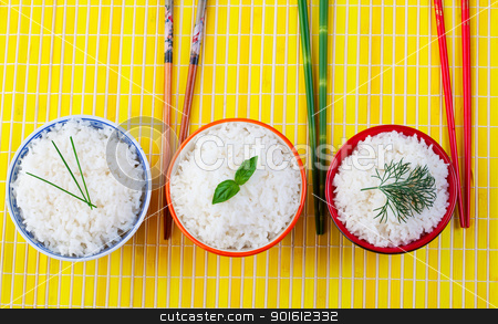 To use this stock image in your creative project, please select the size you need over to the right and click the "Add to Cart" button.
Your downloaded image will come with the Cutcaster watermark removed so don’t worry about the watermark you see on this page. Rice bowls stock photo, Three bowls of rice with chopsticks on a yellow place mat by Steve Mcsweeny