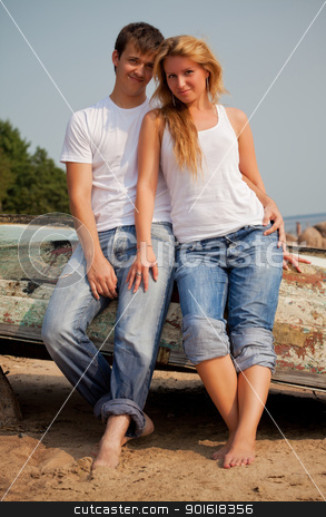 Couple on a beach near old boat couple on a beach near old boat stock photo, beautiful couple on a beach near old boat by Petr Malyshev