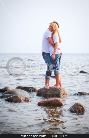 Couple embrace on a stone in sea couple embrace on a stone in sea stock photo, couple embrace on a big stone in sea by Petr Malyshev