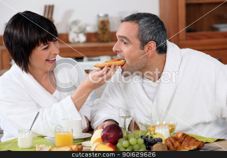To use this stock image in your creative project, please select the size you need over to the right and click the "Add to Cart" button.
Your downloaded image will come with the Cutcaster watermark removed so don’t worry about the watermark you see on this page. Playful couple having breakfast stock photo, Playful couple having breakfast by photography33