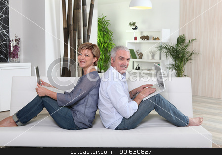 To use this stock image in your creative project, please select the size you need over to the right and click the "Add to Cart" button.
Your downloaded image will come with the Cutcaster watermark removed so don’t worry about the watermark you see on this page. Couple each working on their own laptop stock photo, Couple each working on their own laptop by photography33