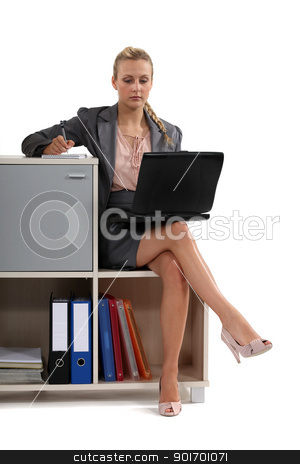 To use this stock image in your creative project, please select the size you need over to the right and click the "Add to Cart" button.
Your downloaded image will come with the Cutcaster watermark removed so don’t worry about the watermark you see on this page. Woman sat with laptop on book case stock photo, Woman sat with laptop on book case by photography33