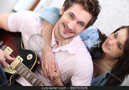 To use this stock image in your creative project, please select the size you need over to the right and click the "Add to Cart" button.
Your downloaded image will come with the Cutcaster watermark removed so don’t worry about the watermark you see on this page. Young couple playing a guitar at home stock photo, Young couple playing a guitar at home by photography33