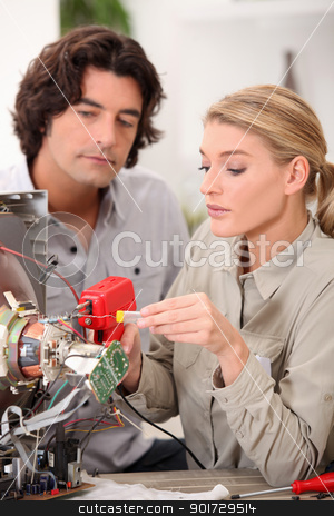 Woman repairing a television set Woman repairing a television set stock photo, Woman repairing a television set by photography33