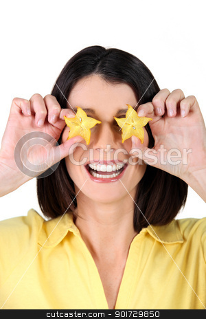 Woman holding slices of starfruit in front of her eyes Woman holding slices of starfruit in front of her eyes stock photo, Woman holding slices of starfruit in front of her eyes by photography33