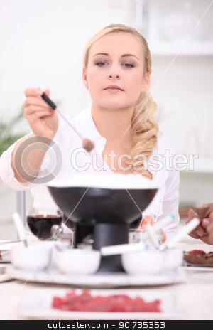 Woman eating steak fondue Woman eating steak fondue stock photo, Woman eating steak fondue by photography33