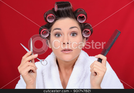To use this stock image in your creative project, please select the size you need over to the right and click the "Add to Cart" button.
Your downloaded image will come with the Cutcaster watermark removed so don’t worry about the watermark you see on this page. Woman with her hair in curlers holding scissors and a comb stock photo, Woman with her hair in curlers holding scissors and a comb by photography33