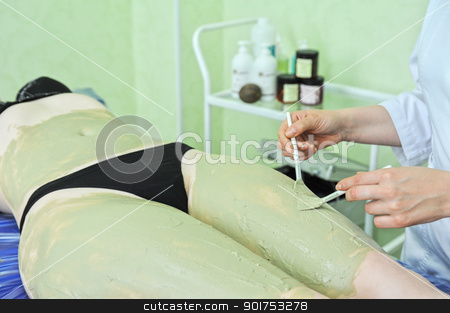 Body mask body mask stock photo, Woman having clay body mask apply by beautician by olinchuk