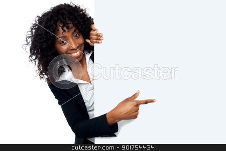 To use this stock image in your creative project, please select the size you need over to the right and click the "Add to Cart" button.
Your downloaded image will come with the Cutcaster watermark removed so don’t worry about the watermark you see on this page. Female representative pointing towards placard stock photo, Female representative pointing towards placard and smiling at camera by Ishay Botbol