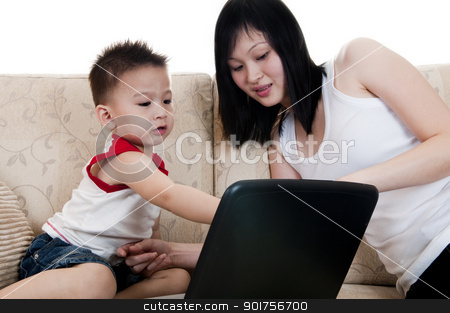 IT education. IT education. stock photo, Young mother with her son using a laptop by szefei