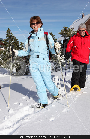 Middle-aged couple skiing to stay fit Middle-aged couple skiing to stay fit stock photo, Middle-aged couple skiing to stay fit by photography33