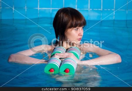 To use this stock image in your creative project, please select the size you need over to the right and click the "Add to Cart" button.
Your downloaded image will come with the Cutcaster watermark removed so don’t worry about the watermark you see on this page. Attractive girl trains in aqua aerobics stock photo, Young beautiful woman doing aqua gym exercise with water dumbbell in a swimming pool by Aikon