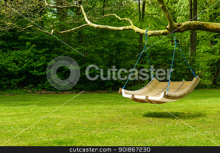 To use this stock image in your creative project, please select the size you need over to the right and click the "Add to Cart" button.
Your downloaded image will come with the Cutcaster watermark removed so don’t worry about the watermark you see on this page. Swing bench in lush garden stock photo, Curved swing bench hanging from the bough of a tree in a lush garden with woodland backdrop for relaxing on those hot summer days by Instudio 68