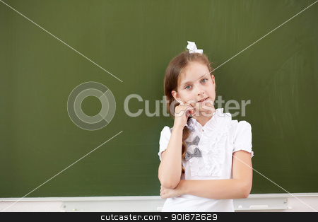 Scoolgirl standing near blackboard Scoolgirl standing near blackboard stock photo, Scoolgirl standing in class near a green blackboard by Sergey Nivens