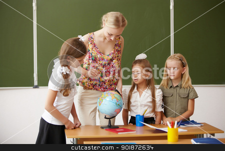 Teacher at school Teacher at school stock photo, Young female teacher working with children at school by Sergey Nivens