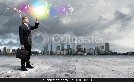 Businessman and cityscape Businessman and cityscape stock photo, Image of a business man standing against cityscape by Sergey Nivens